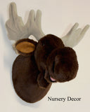 Plush moose head on a white background, labeled 'Nursery Decor'.