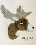 Plush deer head wall decoration with antlers and red nose on a white background