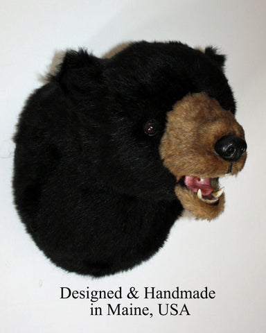 Stuffed plush bear head with black fur and tan muzzle on a white background, labeled 'Designed & Handmade in Maine, USA'.